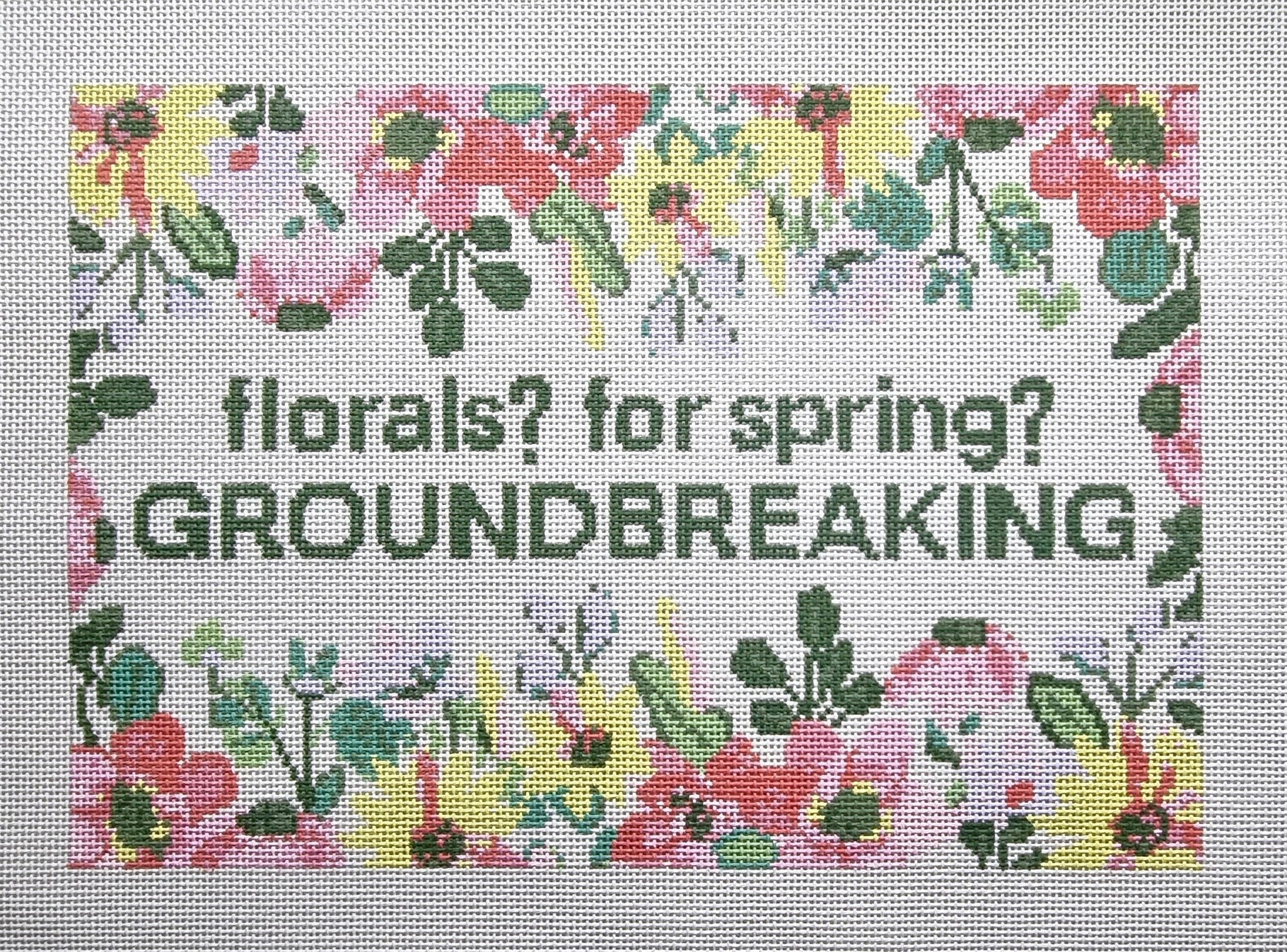 needlepoint pattern with floral design and text 'florals? for spring? GROUNDBREAKING'.