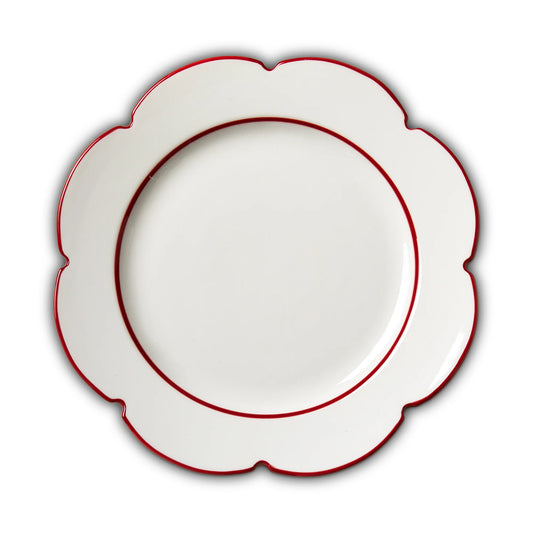A white ceramic plate with a scalloped edge and a thin red rim, shown from a top-down view on a white background.