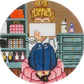 Circular needlepoint or cross-stitch design of a person in a blue coat and pink dress with a cityscape background.