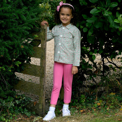 child wearing a green jacket outside