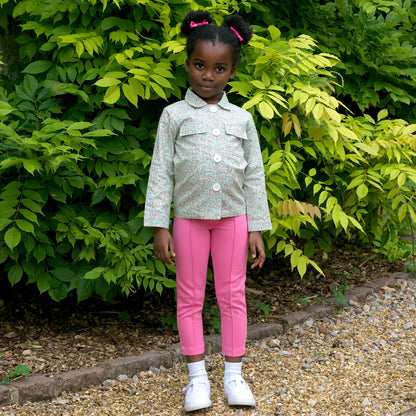 child wearing a green jacket outside
