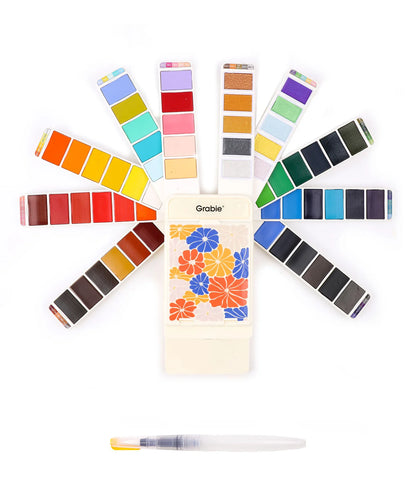 Color swatch book with various color samples and a pen on a white background