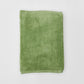 Green towel on a white background