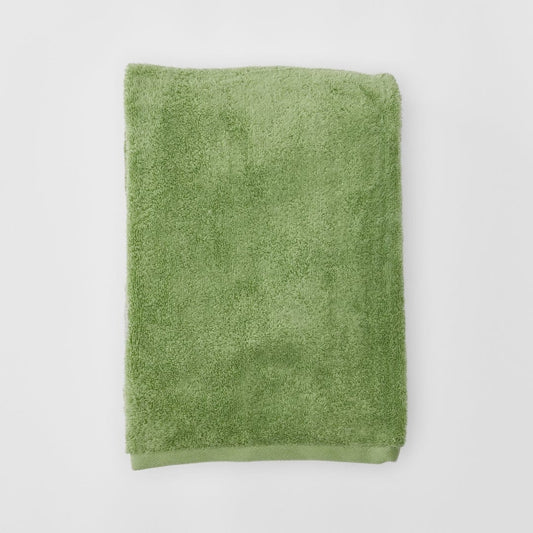 Green towel on a white background