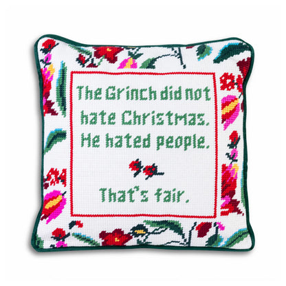 Decorative pillow with embroidered text and floral patterns on a white background
