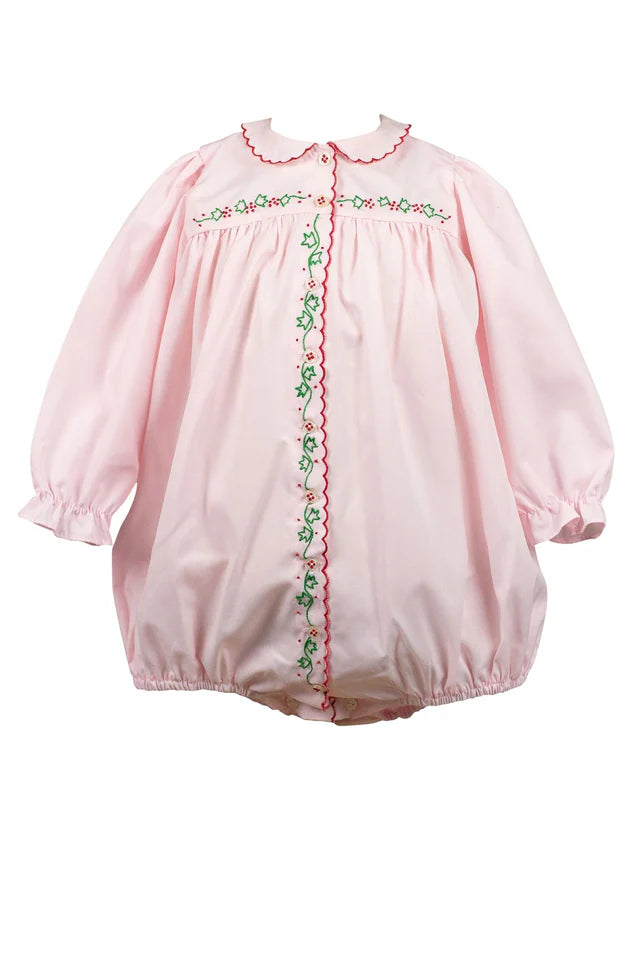 Pink baby romper with embroidered details on a white background