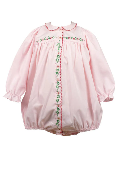 Pink baby romper with embroidered details on a white background