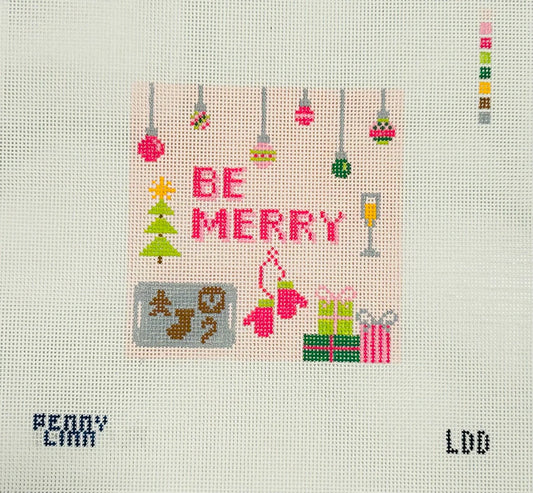 A square needlepoint canvas featuring a festive Christmas design with the words 'BE MERRY' in pink, a green tree, ornaments, gifts, and holiday motifs on a white mesh background.