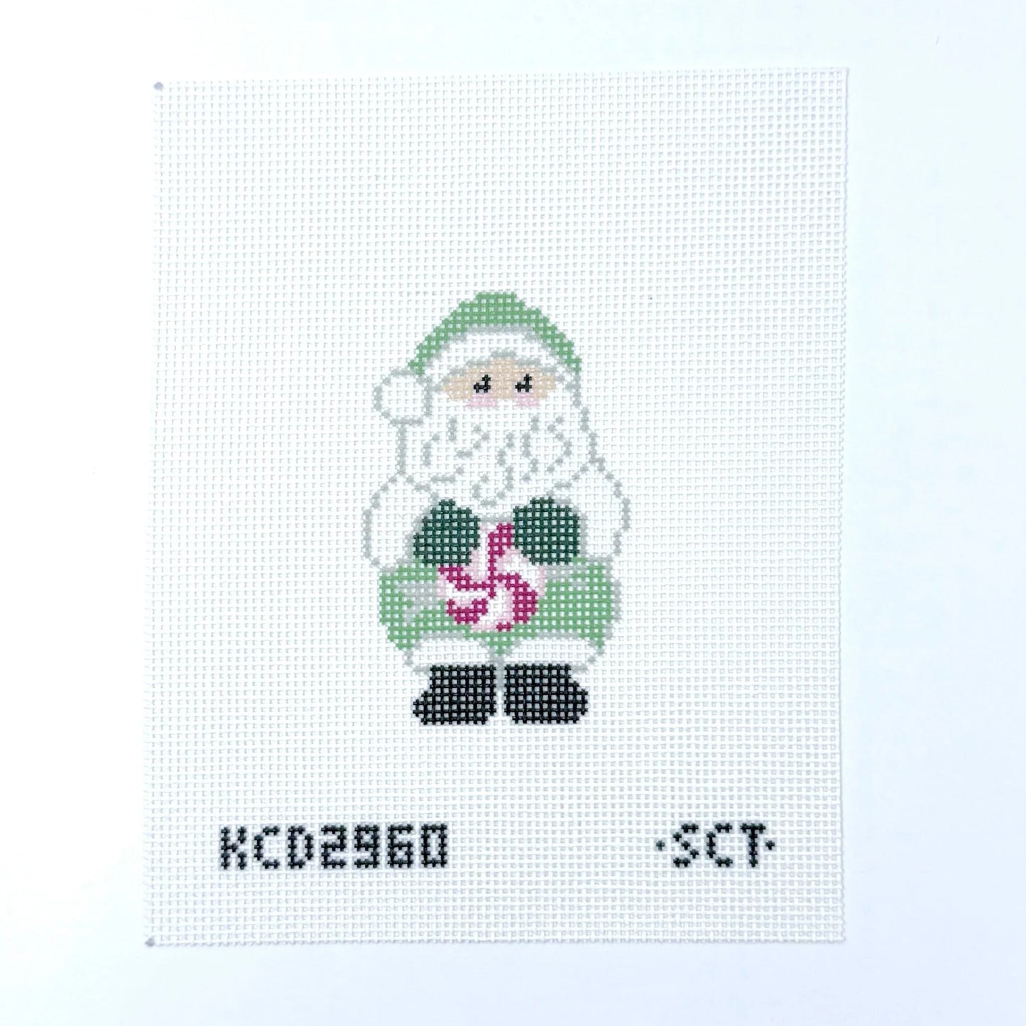 Cross-stitched pattern of a Santa Claus figure with a candy cane on a white background.