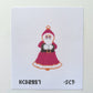 Cross-stitched pattern of a character in a red dress with a white background