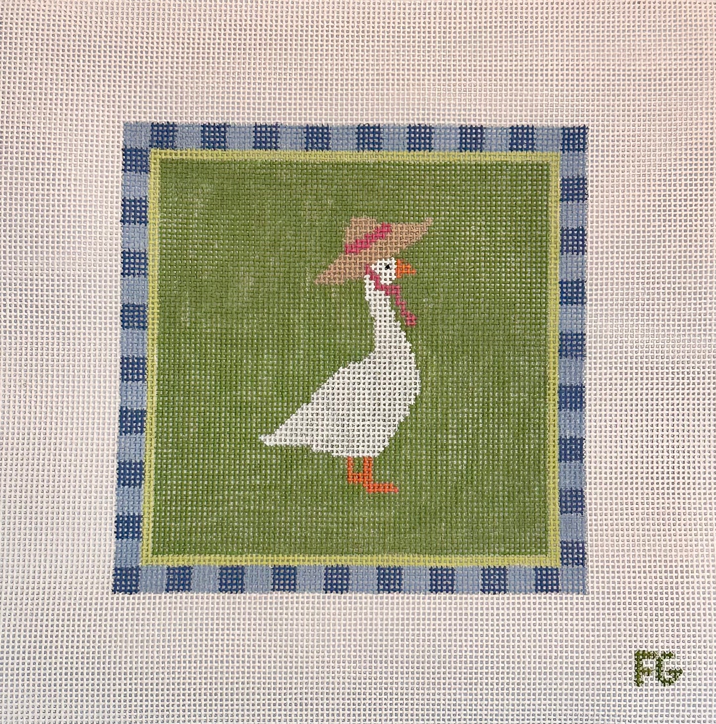 A square needlepoint canvas featuring a white goose wearing a brown hat with a pink band, set against an olive green background with a blue and white checkered border. The canvas is displayed flat against a white mesh background.