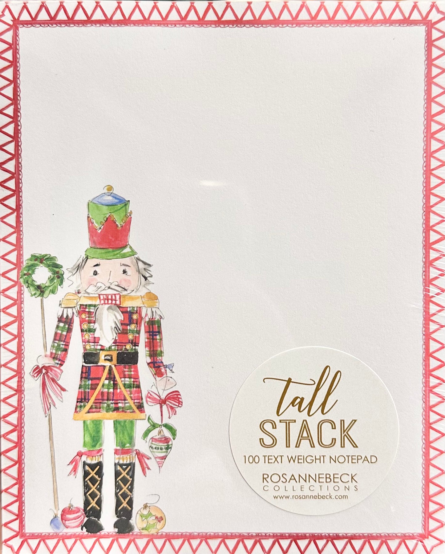 A tall stack notepad by Rosanne Beck Collections featuring a festive nutcracker illustration on the left and a circular label reading 'tall STACK' on the right, set against a white background with a red patterned border.