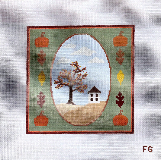 A square needlepoint canvas featuring a fall landscape design. The design has a green border with orange pumpkins, brown and yellow leaves, and a central oval showing a tree with brown and orange leaves, a small house, and a light blue sky.
