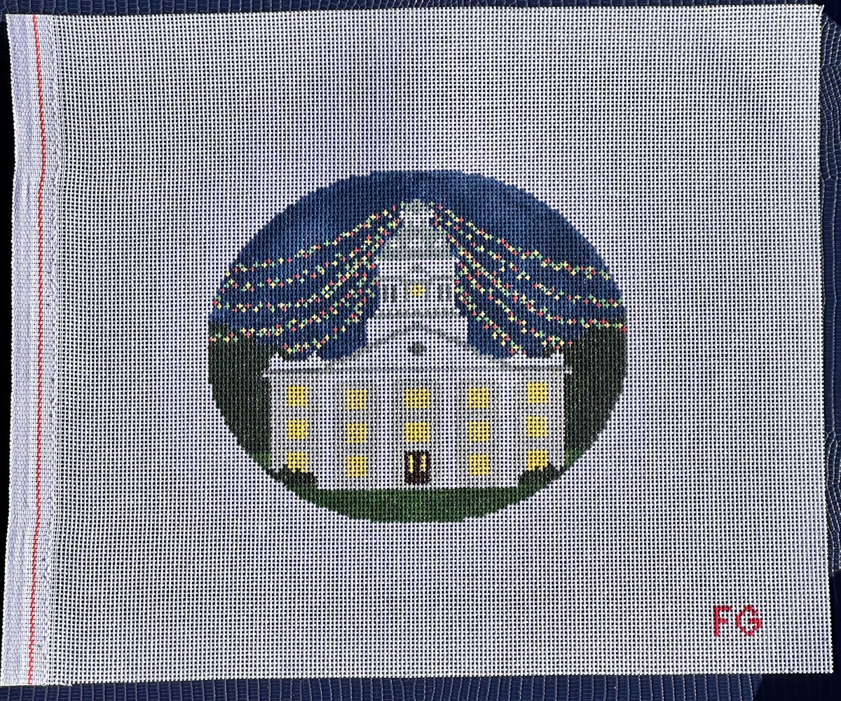needlepoint canvas with white building and christmas lights 