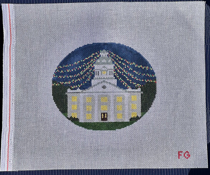 needlepoint canvas with white building and christmas lights 