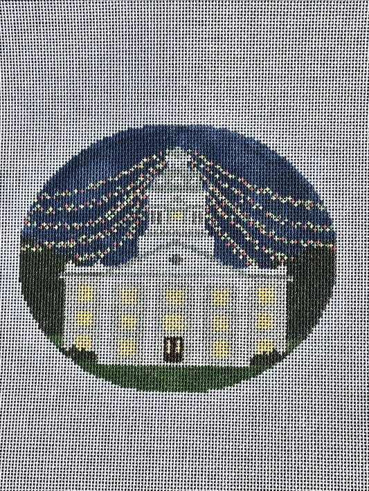 needlepoint canvas with white building and christmas lights 