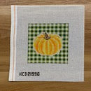 Handkerchief with a yellow pumpkin and text on a wooden surface