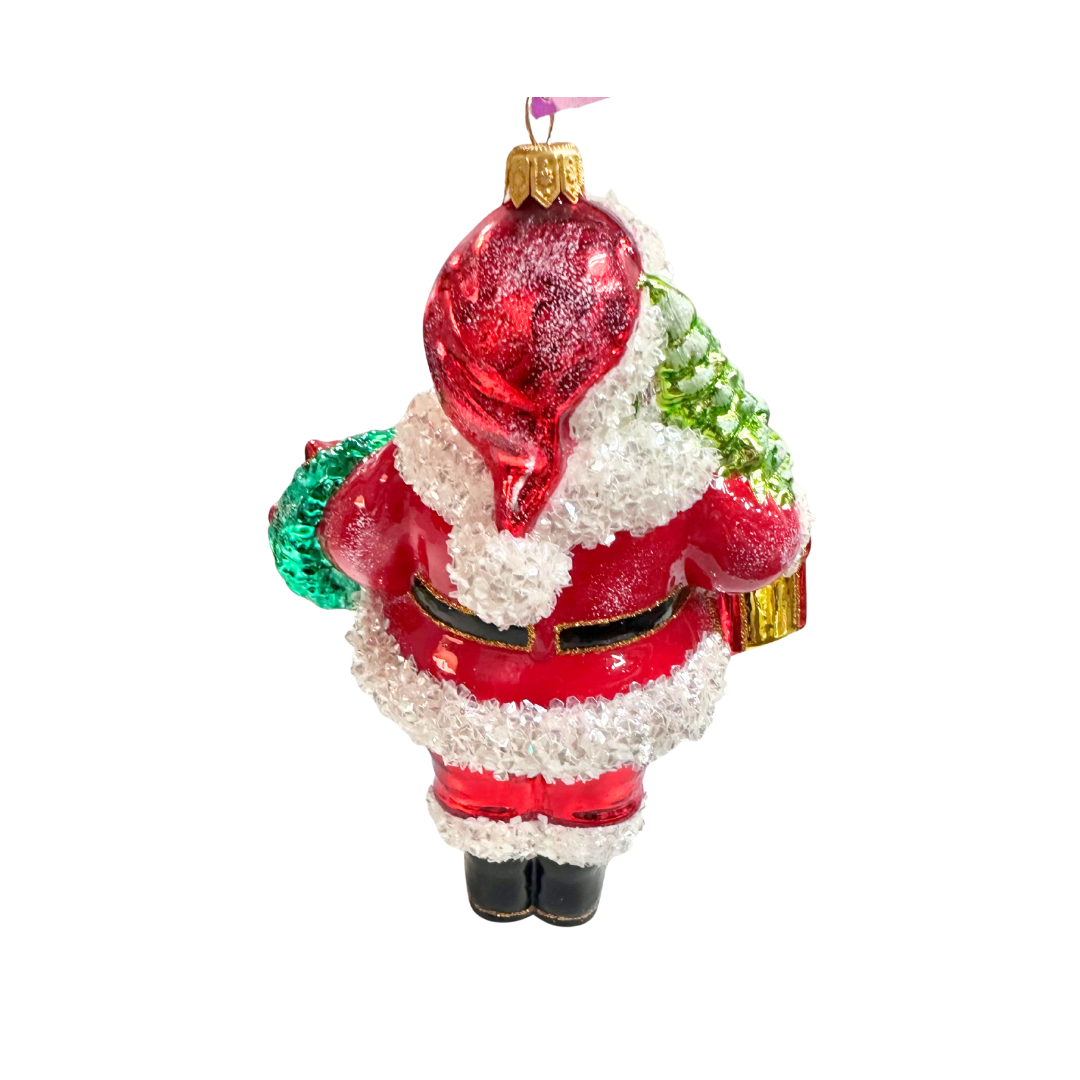 Decorative glass ornament of Santa Claus holding a red sack on a white background