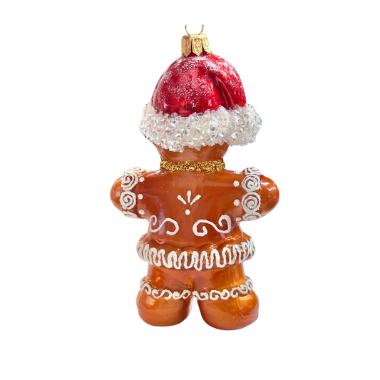Decorative gingerbread man ornament with a red hat on a white background