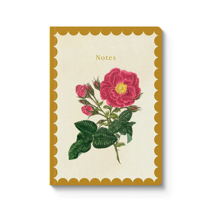 A vertical notebook with a cream-colored cover, featuring a vintage-style illustration of a pink rose with green leaves. The notebook has a scalloped mustard-yellow border and the word 'Notes' printed near the top.