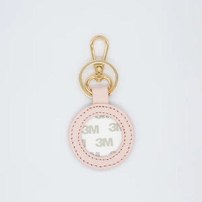 A light pink leather keychain ring with a gold-tone metal carabiner and key ring, featuring a clear protective cover with visible 3M brand tape underneath.