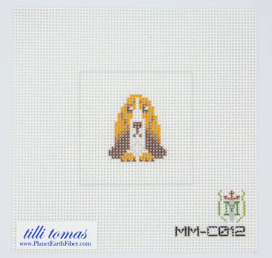 Cross-stitched dog design on fabric with 'tillietomas' branding and pattern number.
