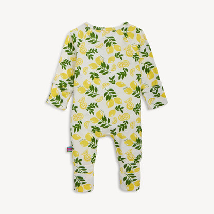 Baby onesie with lemon and leaf pattern on a white background