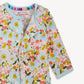 Floral-patterned baby outfit with 'magnetic me' label on a light background