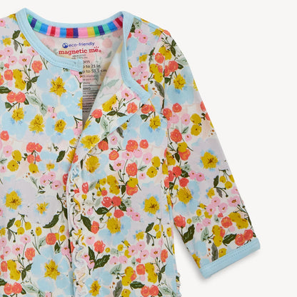 Floral-patterned baby outfit with 'magnetic me' label on a light background