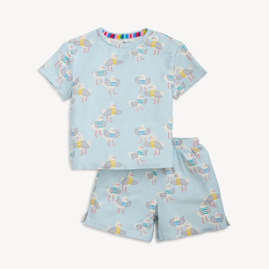Children's pajama set with dog pattern on a light blue background