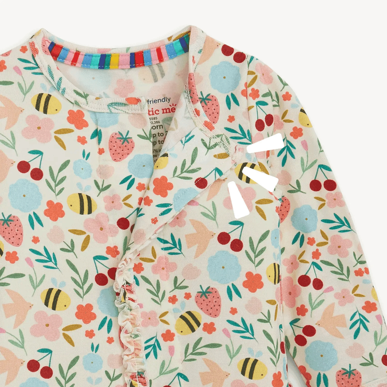 Children's onesie with floral and fruit pattern on a white background
