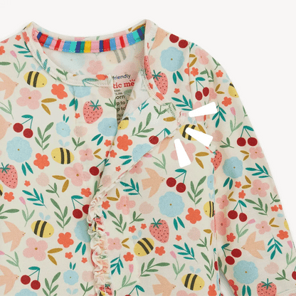 Children's onesie with floral and fruit pattern on a white background