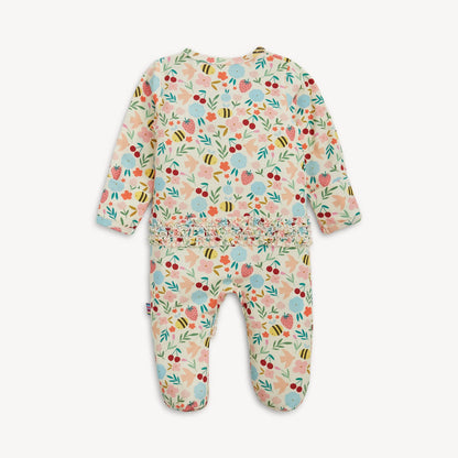 Floral patterned baby onesie on a white background