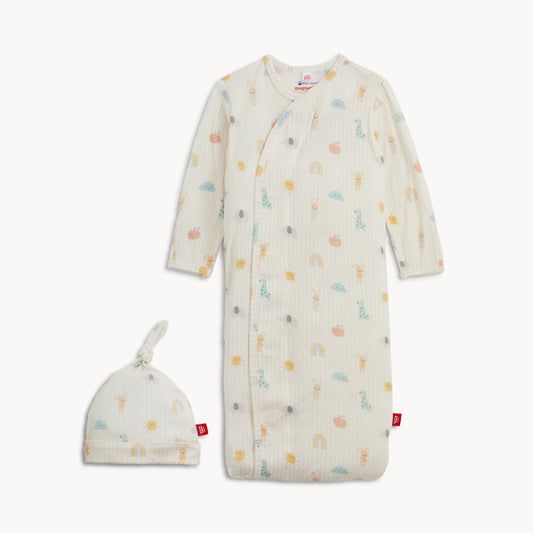 Baby gown with colorful patterns and matching hat on a white background