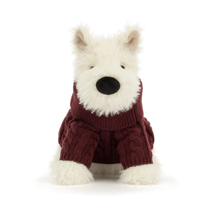 A plush dog toy wearing a burgundy cable-knit sweater, photographed against a seamless white background.