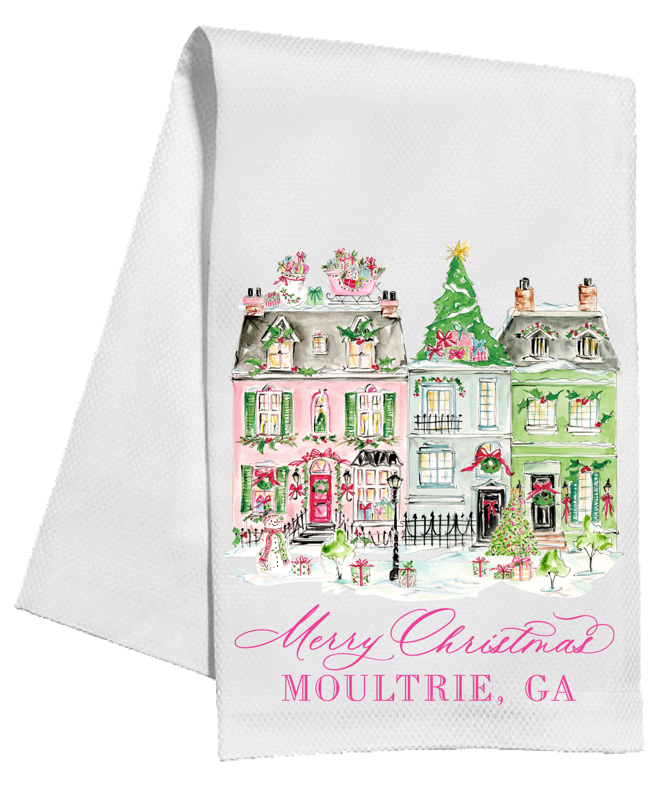 A white kitchen tea towel featuring a colorful watercolor illustration of holiday houses in Moultrie, GA, with 'Merry Christmas' and 'MOULTRIE, GA' printed in pink script and block lettering at the bottom.