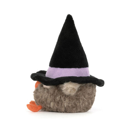 Plush toy resembling a bird with a black witch hat on a white background