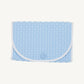 Blue quilted clutch bag with white strap on a white background