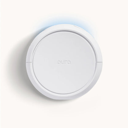Round white device with 'aura' branding on a light gray background