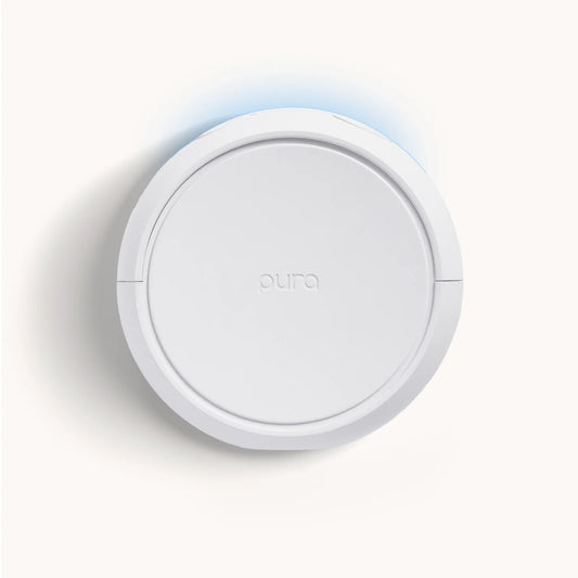 Round white device with 'aura' branding on a light gray background
