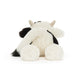 Plush cow toy on a white background