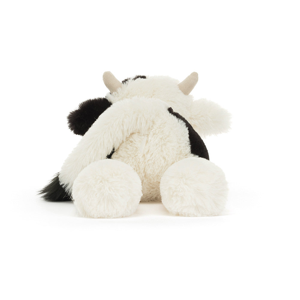 Plush cow toy on a white background