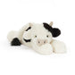 Plush cow toy with black accents on a white background