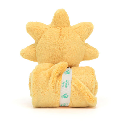 A plush toy in the shape of a sun with a smiling face, attached to a golden security blanket or soother.