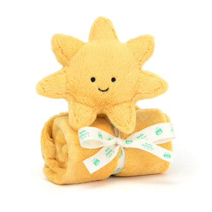 A plush toy in the shape of a sun with a smiling face, attached to a golden security blanket or soother.
