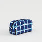 Blue and white checkered toiletry bag on a light gray background