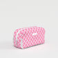 Pink and white checkered toiletry bag on a light gray background