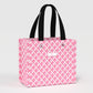 Pink lattice patterned tote bag with black handles on a light gray background