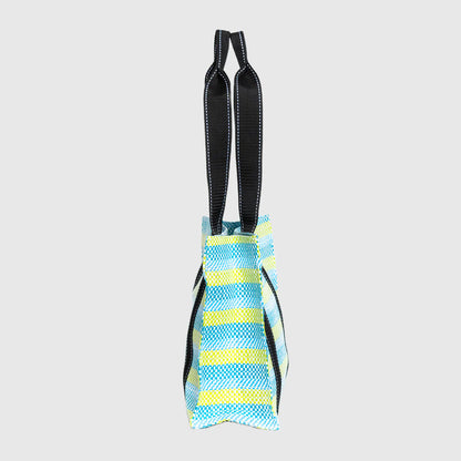 Blue and yellow striped dog toy with black handles on a light gray background