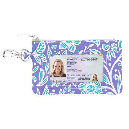 Floral patterned ID holder with a clear window for an ID card on a white background